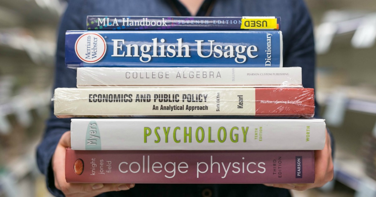 a student holding textbooks in their hands