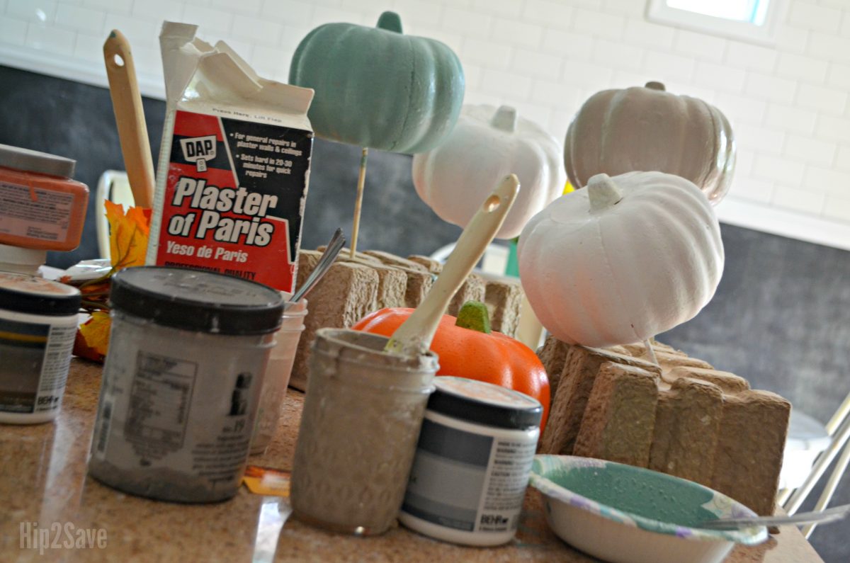 painted pumpkins drying while on sticks