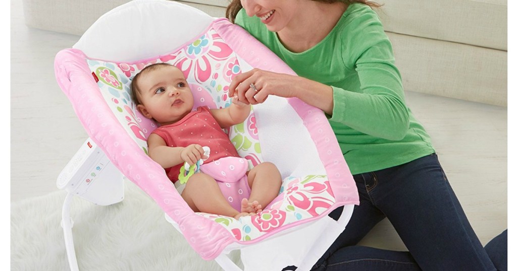 woman tending to baby in Rock N Play sleeper