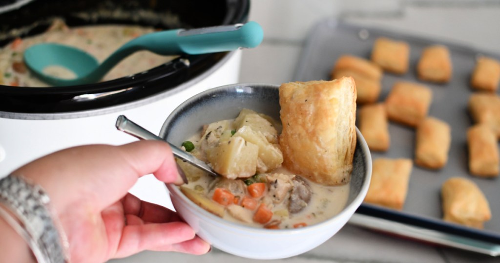 holding a bowl of chicken pot pie soup