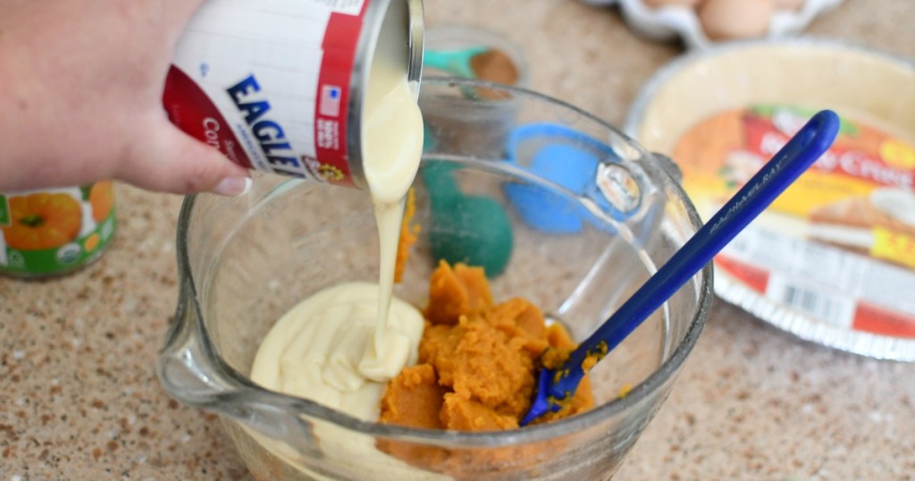 pouring in a can of condensed milk into a dessert