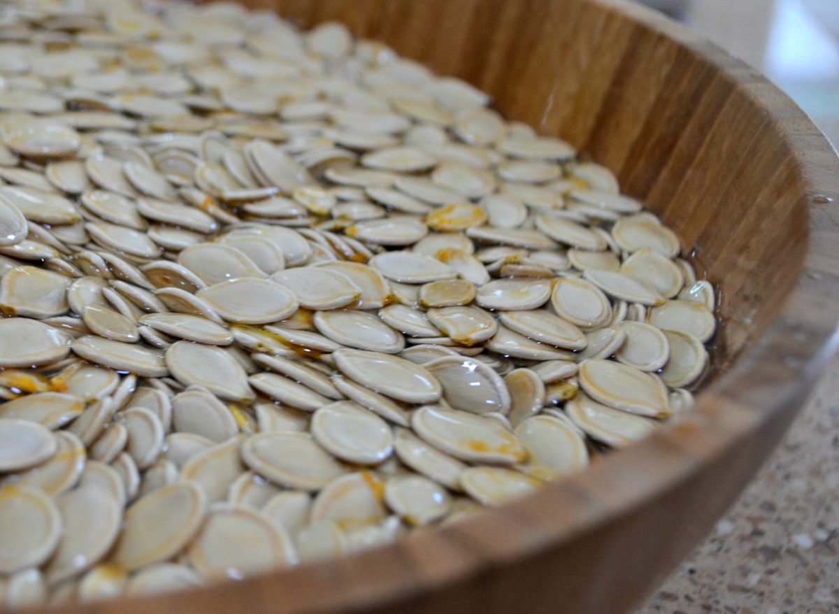 pumpkin seeds soaking in a bowl of water