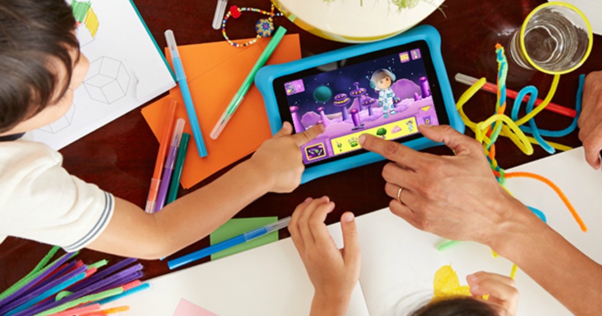 kids and parent using the amazon fire tablet with arts and craft things around it