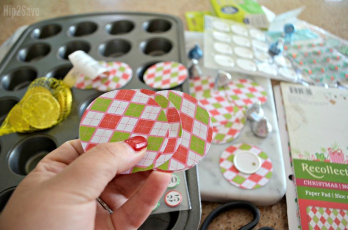 holding circles of red and green paper