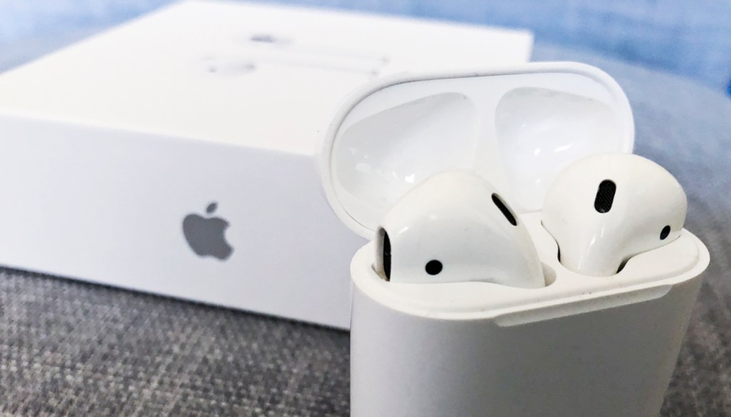 Apple AirPods in case next to box 