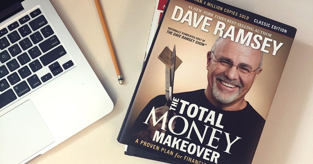 dave ramsey book next to onlineputer