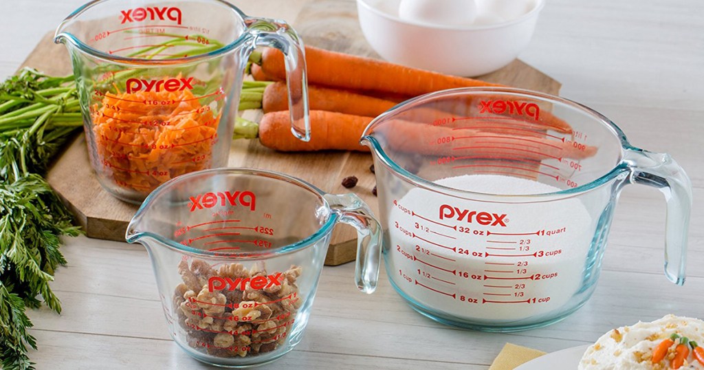 pyrex measuring cups with carrots, milk, and nuts