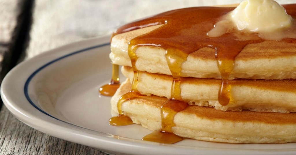 short stack of IHOP pancakes topped with butter on a plate