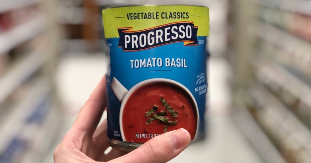 hand holding can of tomato soup