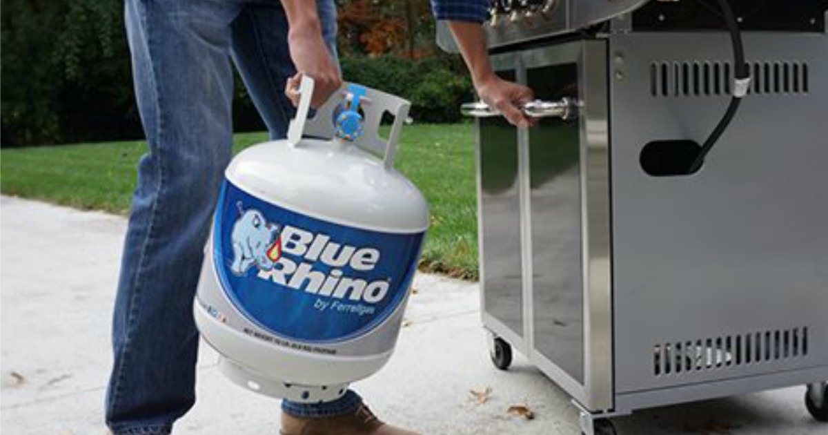 Person putting Blue Rhino Tank on their grill