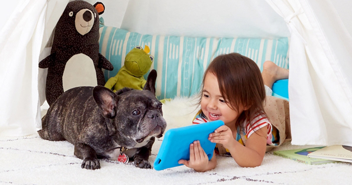 little girl showing her bulldog her amazon fire tablet