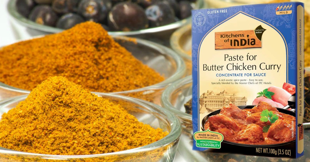 kitchens of india butter chicken curry box next to bowl full of spices