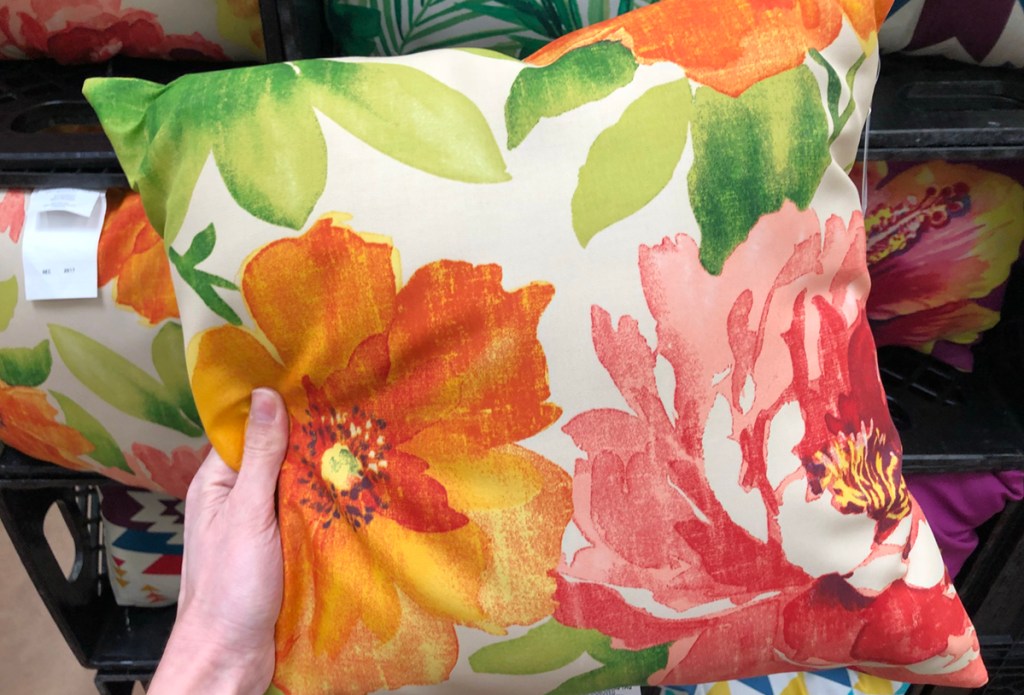 holding floral throw pillow 