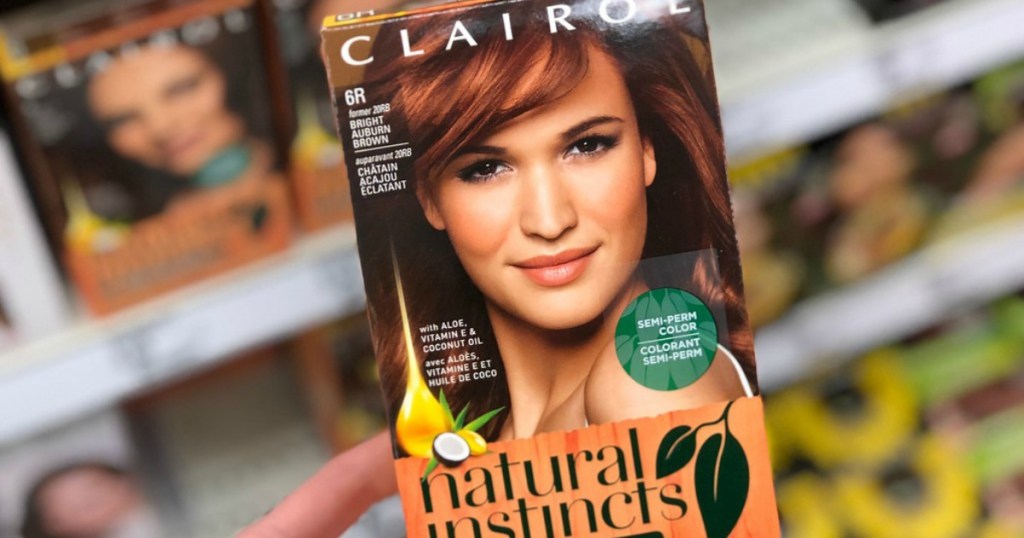 Hand holding a Clairol hair dry box