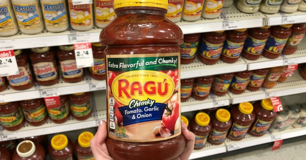 ragu chunky jar being held by hand in grocery store aisle