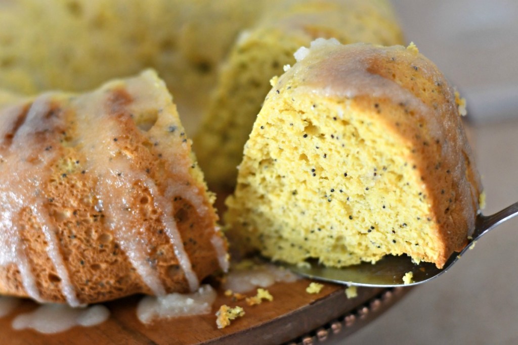 slice of sherry poppy seed cake on a cake stand 