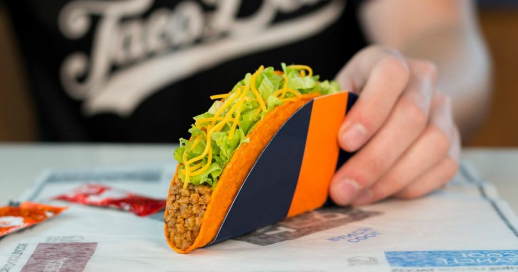 person holding a Taco Bell taco