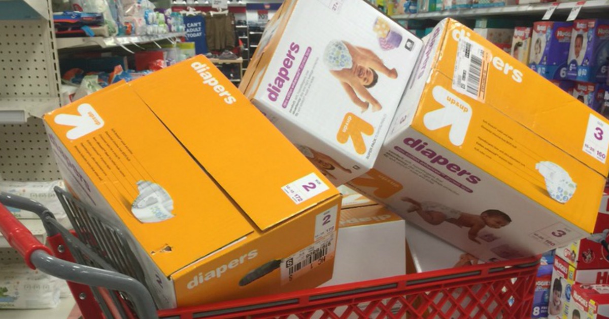 Large boxes of diapers in a red shopping cart in-store