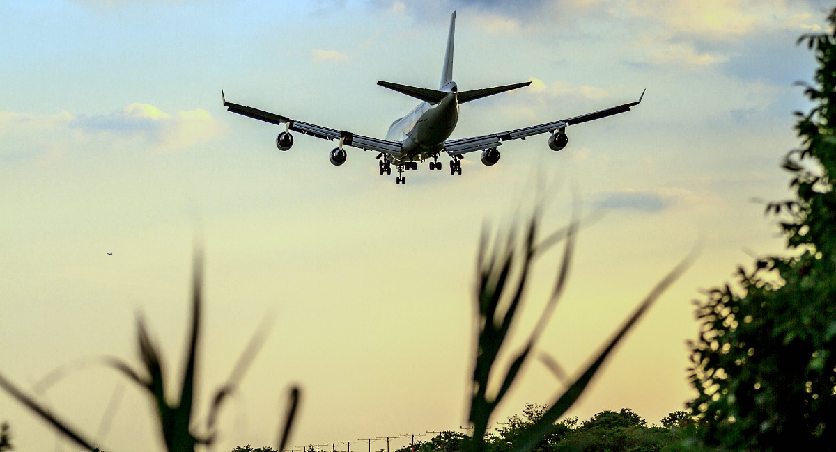 airplane landing with sunset in background