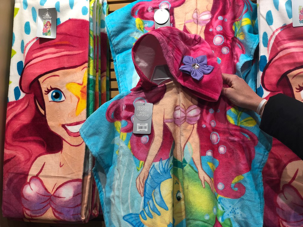 Ariel hooded towel hanging on rack at store