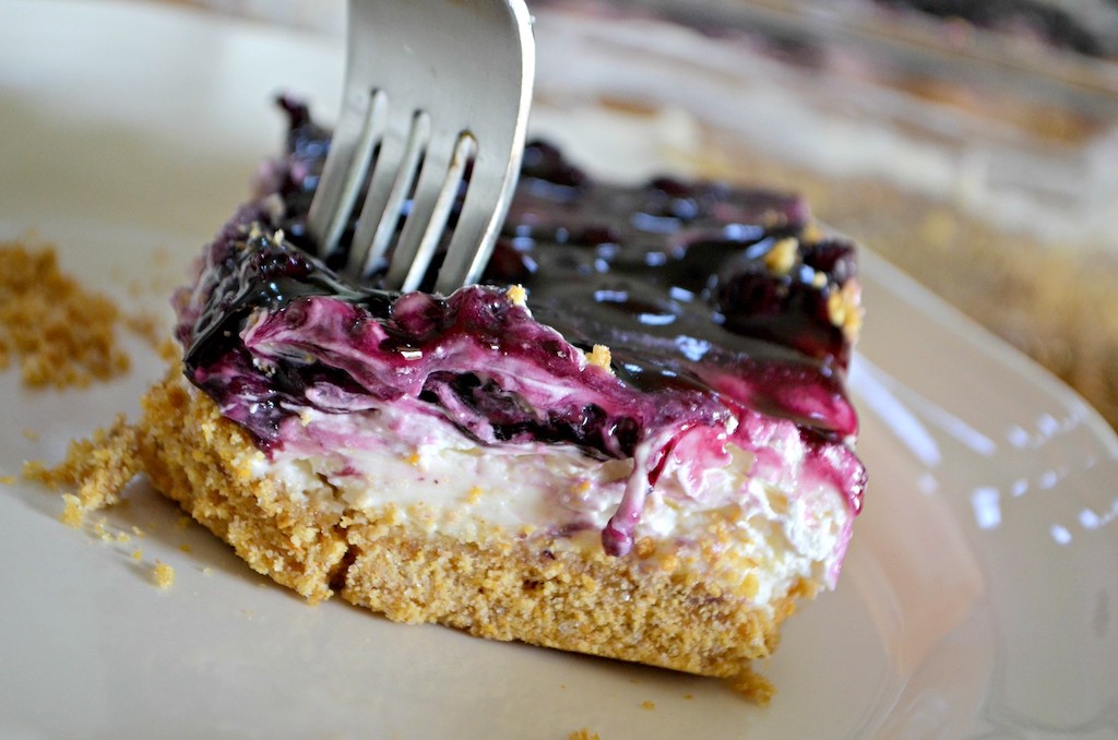 fork in blueberry cheesecake dessert