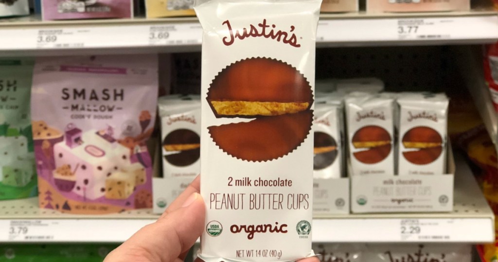 Hand holding a Justin's Peanut Butter cup pack