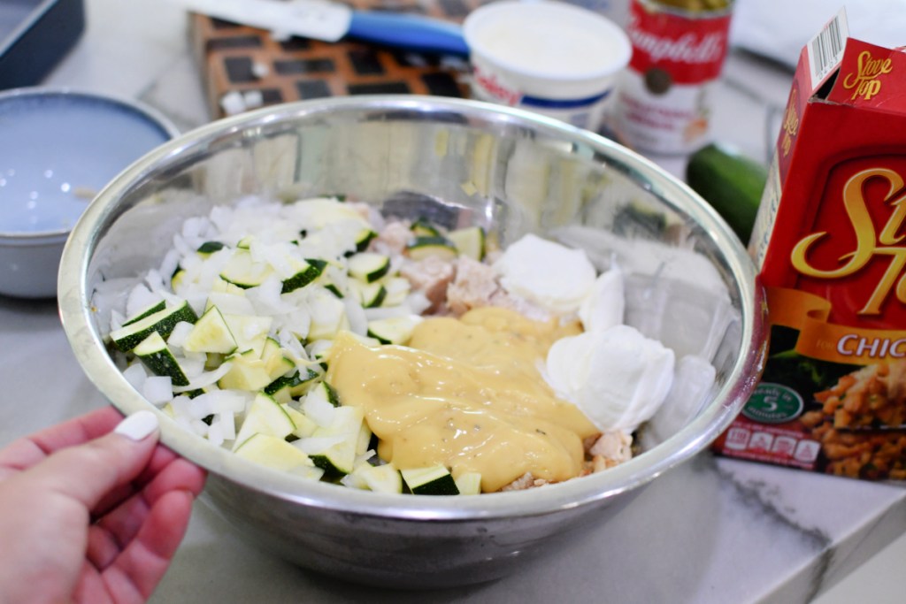 adding cream of chicken soup and sour cream to casserole