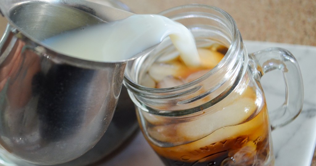 pouring in creamer to cold brew