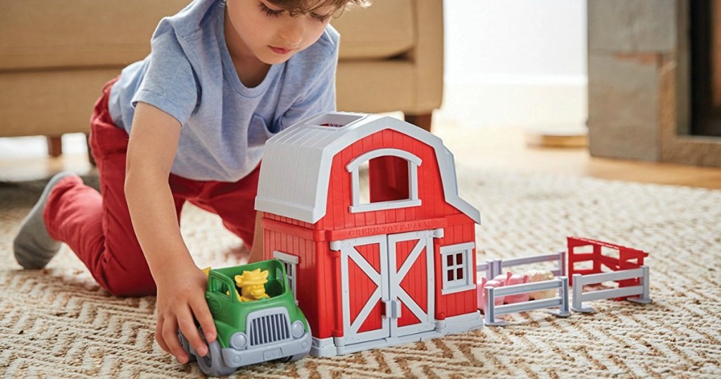 boy playing with farm play set