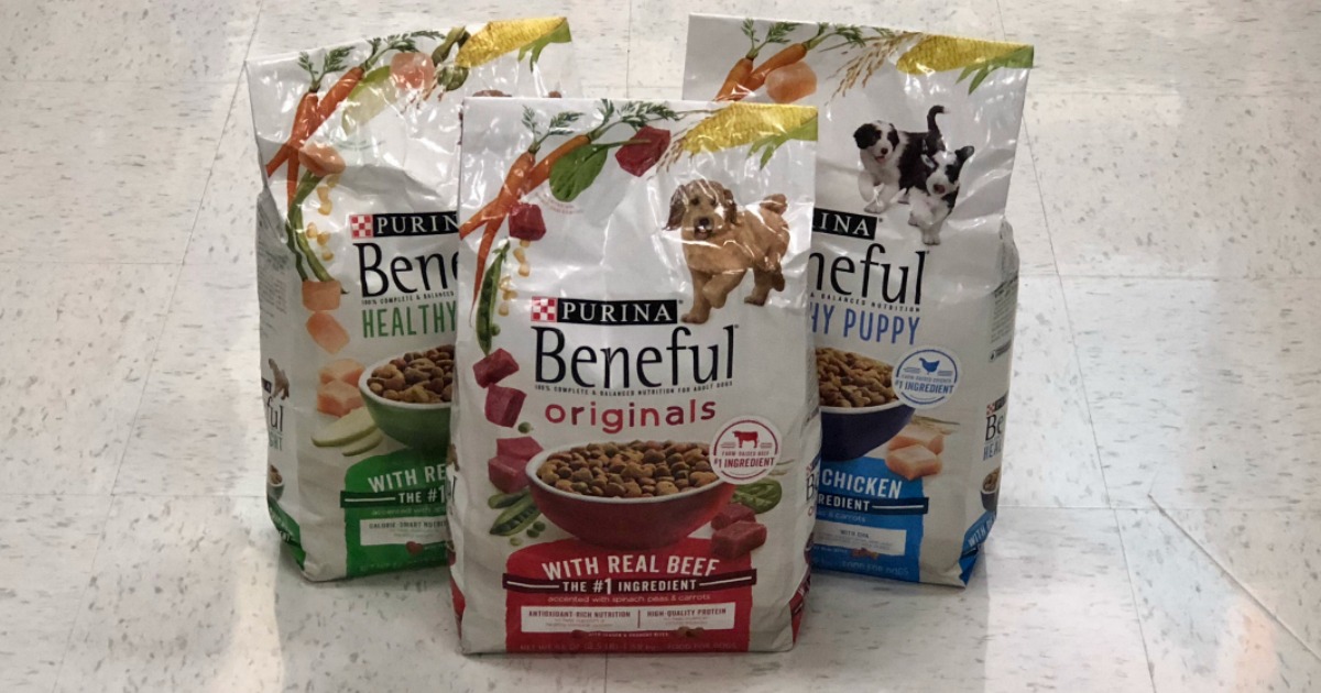 three bags of Purina Beneful dog food sitting on a store floor