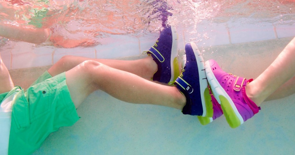 two kids in a pool with Stride Rite Water shoes on