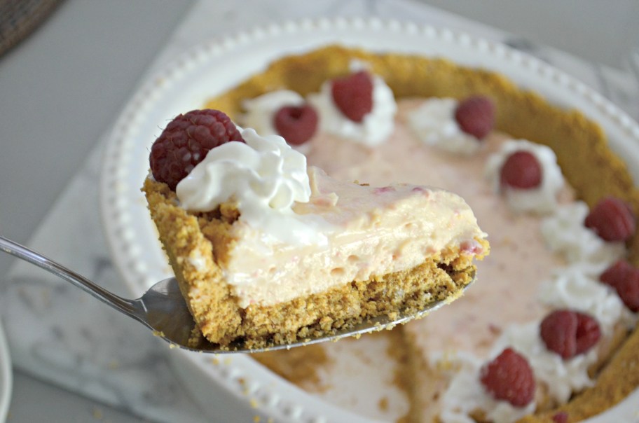 cutting a slice of raspberry pie