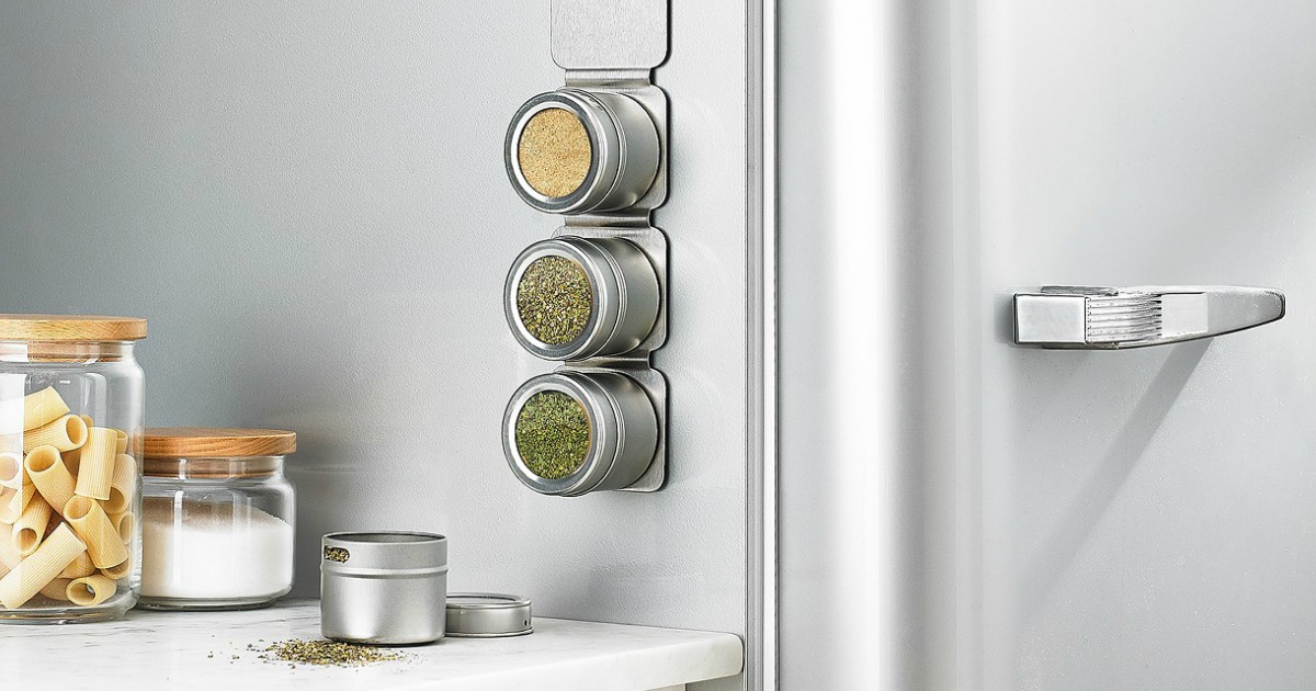 magnetic strip of spice containers handing on side of fridge