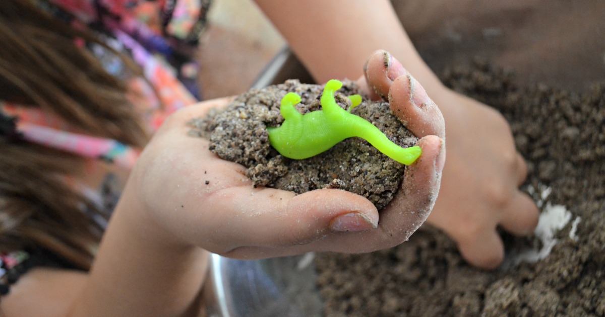 holding dinosaur surprise egg toys in hands