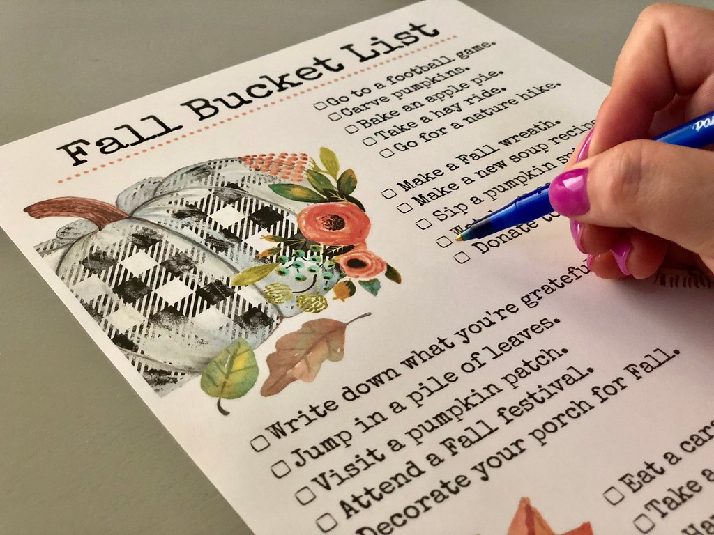 places for free fun fall activities — woman filling out her fall bucket list