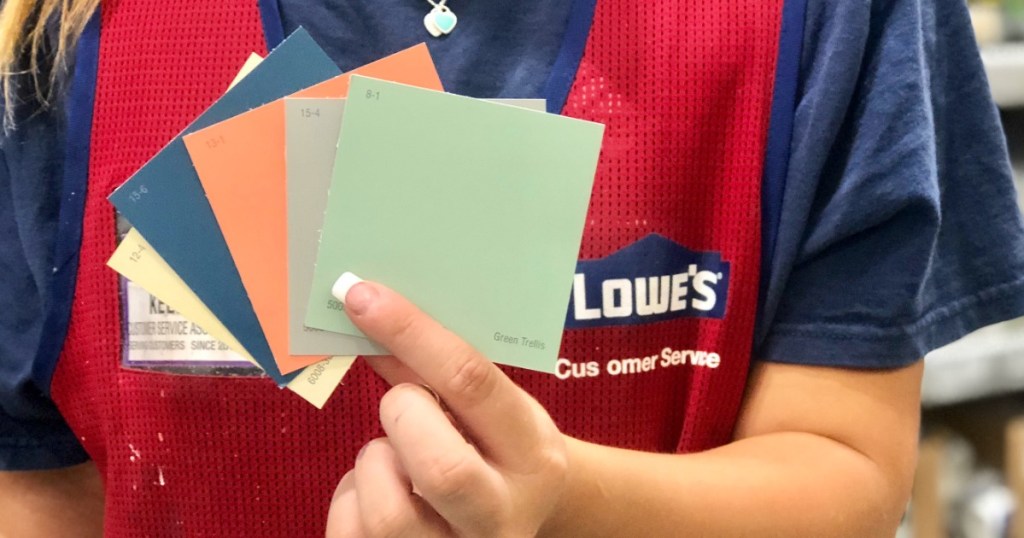 woman at Lowe's holding paint samples 