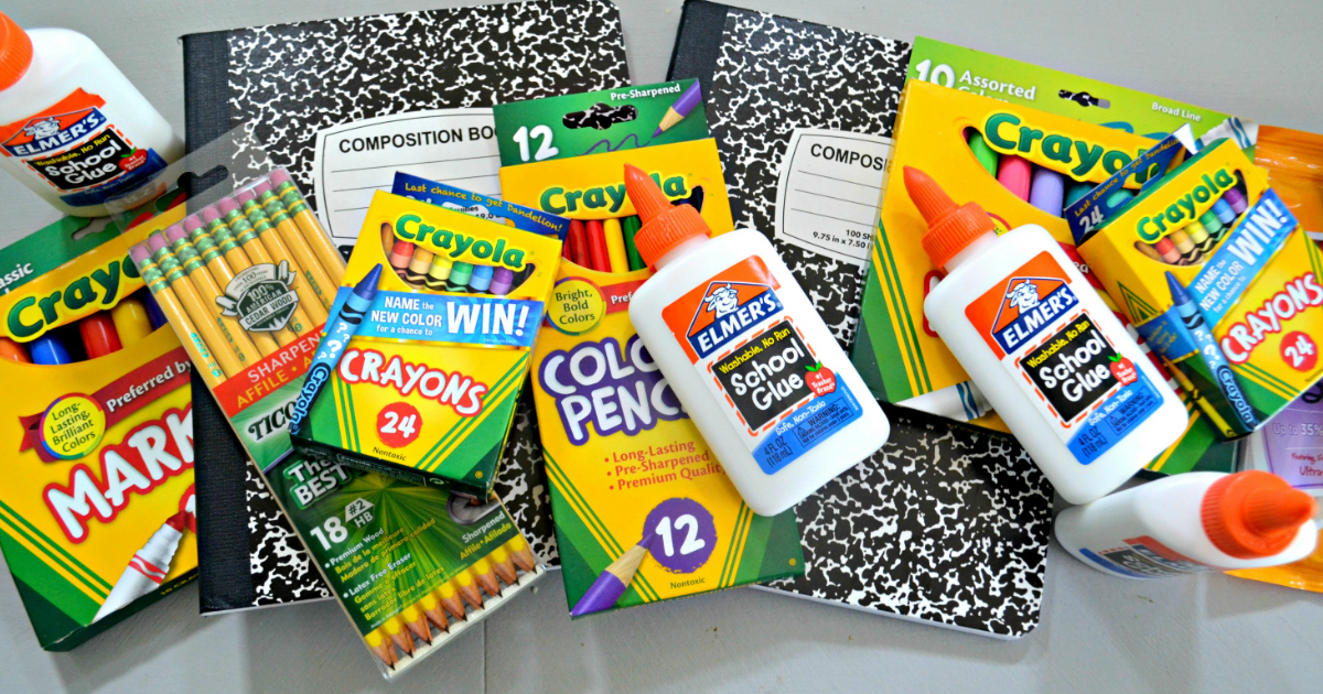 School supplies in a pile, including glue, pencils, onlineposition notebooks, and crayons