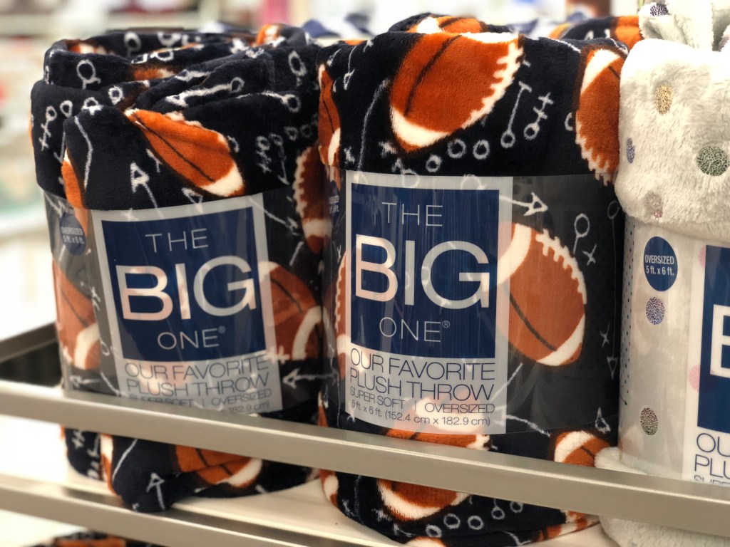 the big one football themed soft plush throw in store on shelf