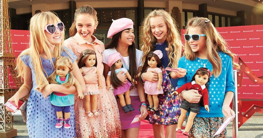 Little girls holding American girl dolls