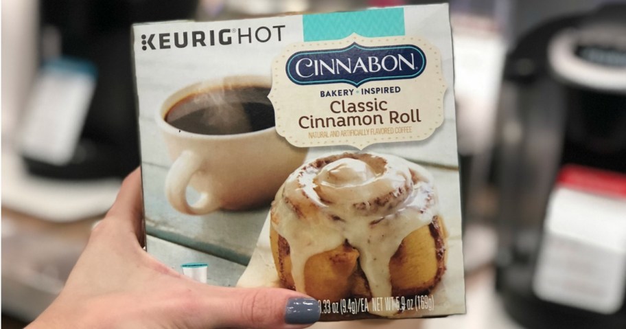 hand holding box of Cinnabon k-cups