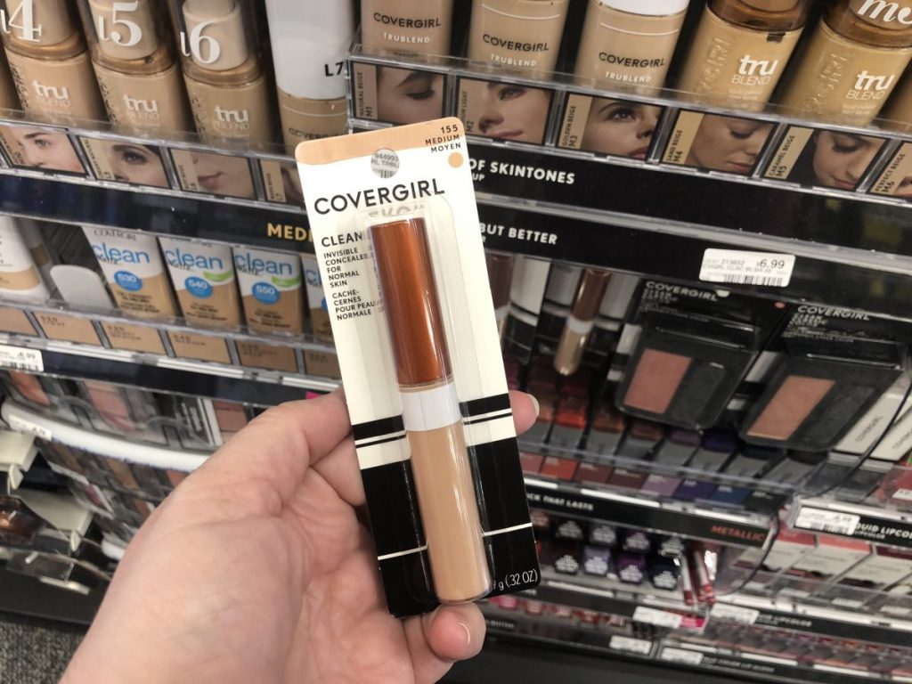 hand holding up a concealer makeup in store