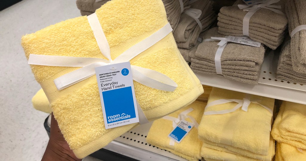 woman holding room essentials towel