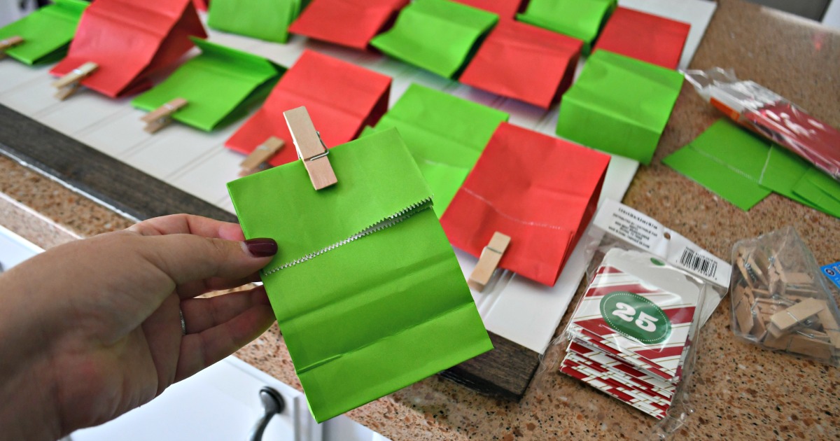 hand holding green bag for frugal christmas traditions advent calendar 