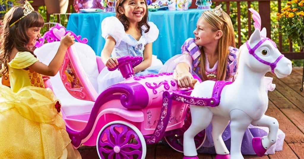 kids playing with the disney ride on carriage toy