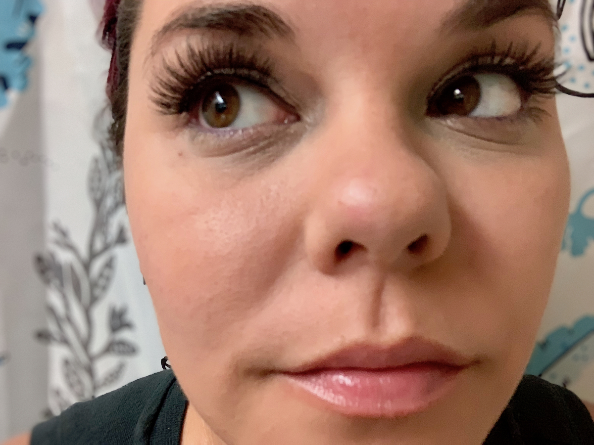 close up of woman's face wearing false eyelashes