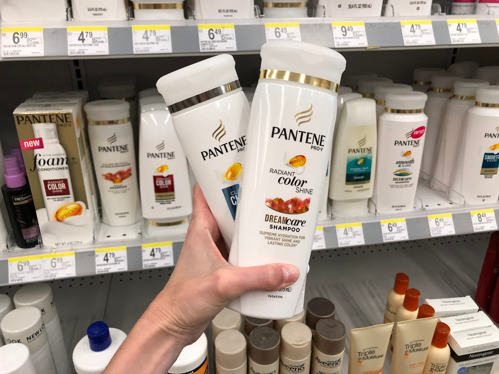 two bottles of pantene criss-crossed in hand