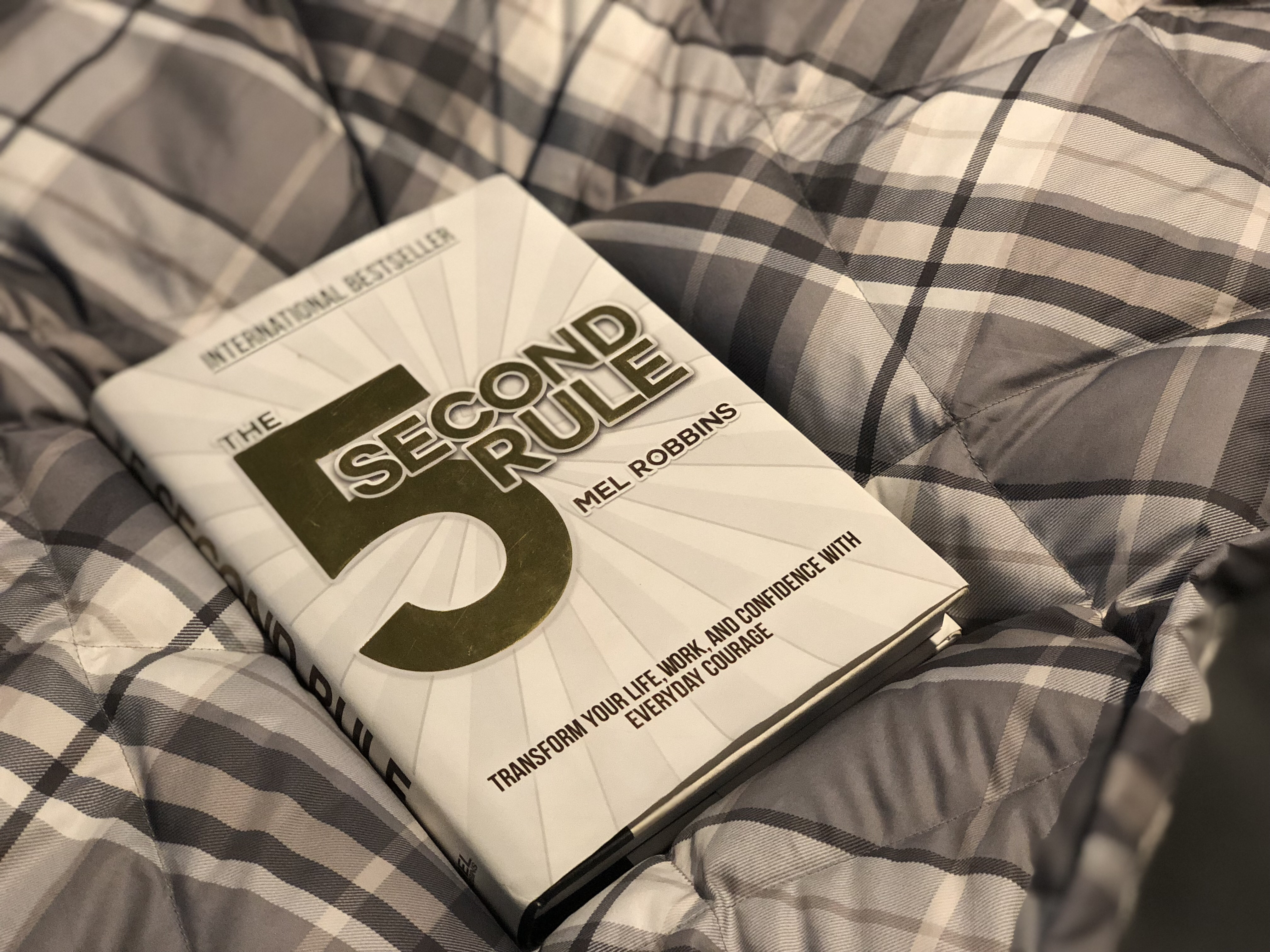 changed life 5 seconds – closeup of the book The 5 Second Rule by Mel Robbins on the bed