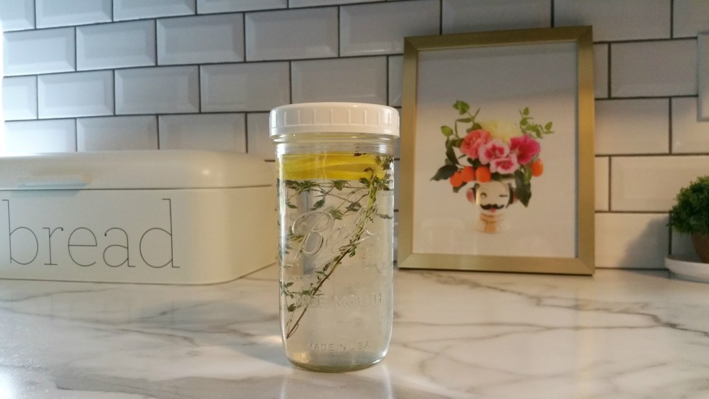 herbs and lemon slice in water, one of our favorite kitchen hacks