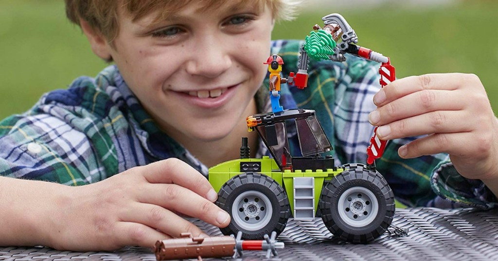 child playing with LEGO tractor