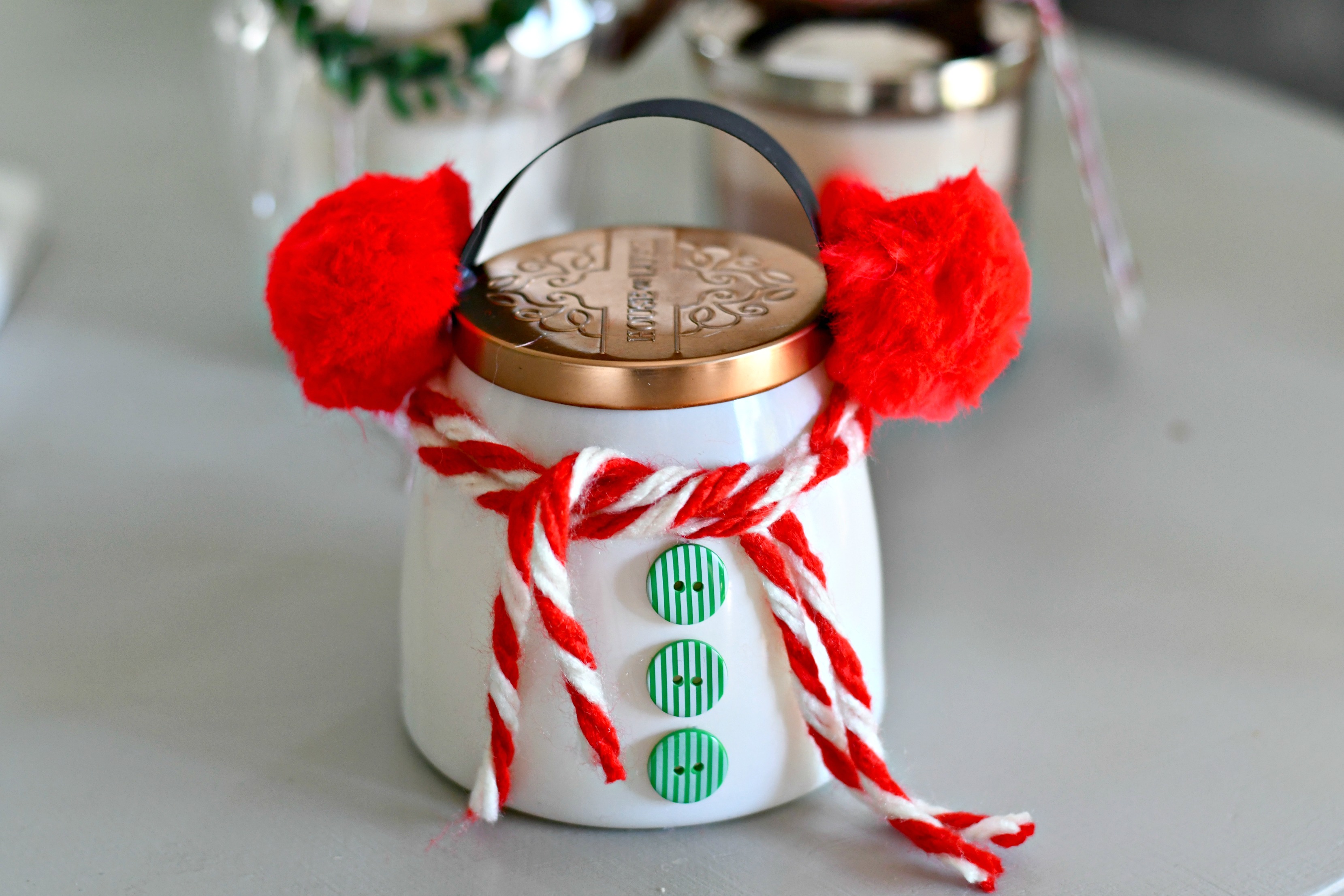 snowman candle with earmuffs